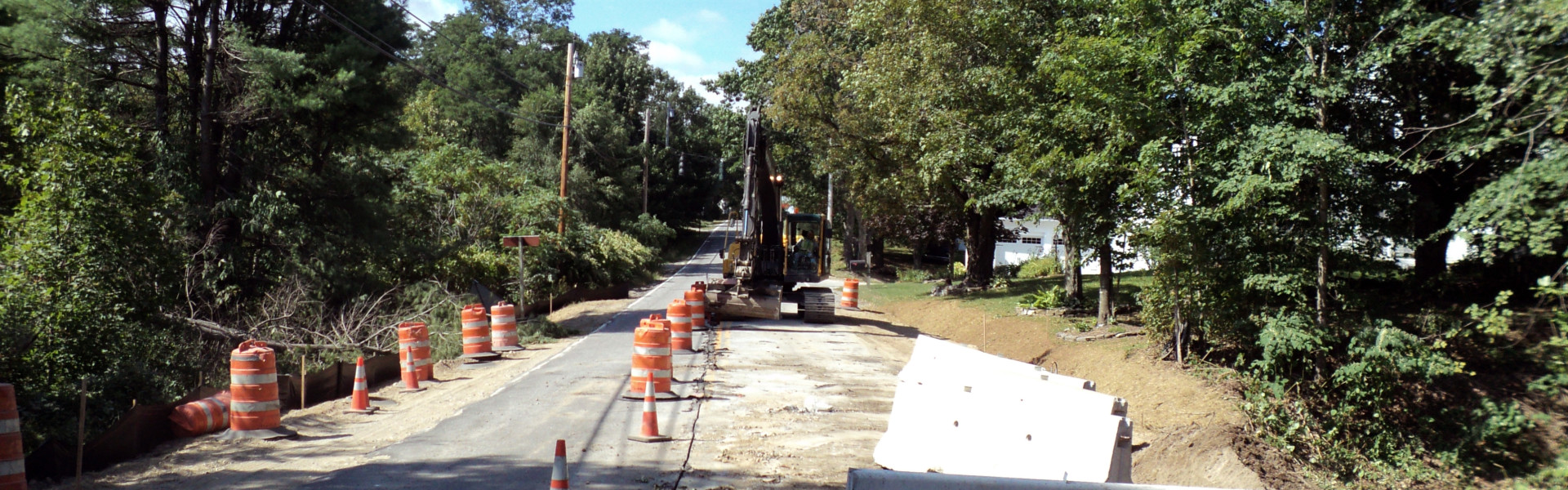 Quiet Road Construction Site with Equipment and Safety Cones